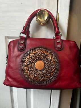 Red Leather Satchel Handbag with Embossed Medallion